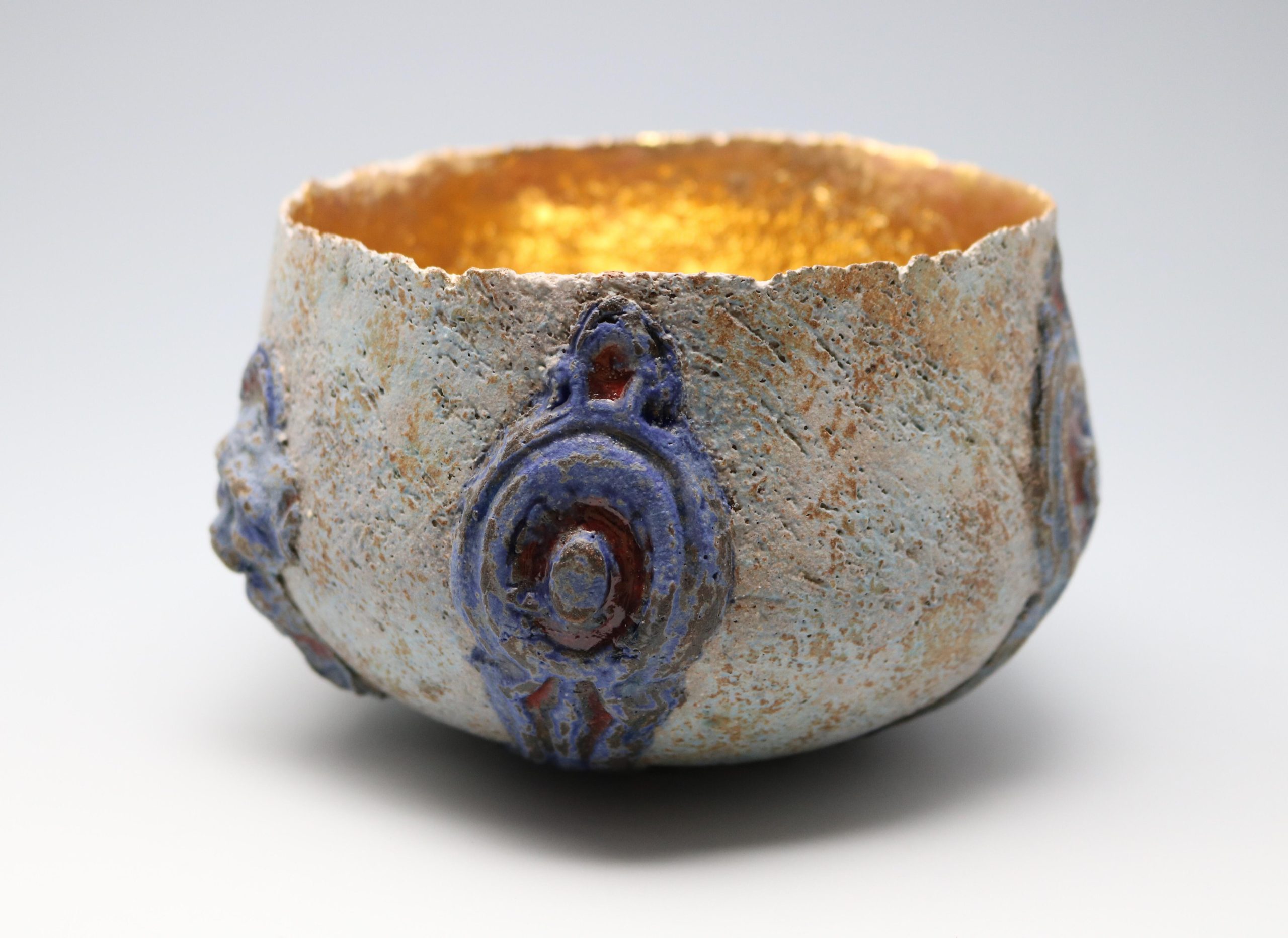 Phil Jolley: Stoneware vessel. Sprig decoration and gold interior