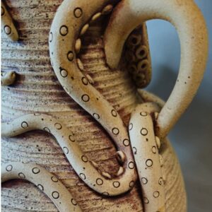 Abby Mason: Close up of iron oxide washed vase handle with octopus arms wrapped around